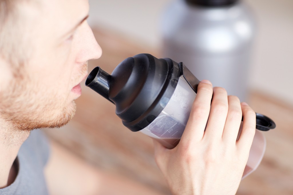 close up of man drinking protein shake